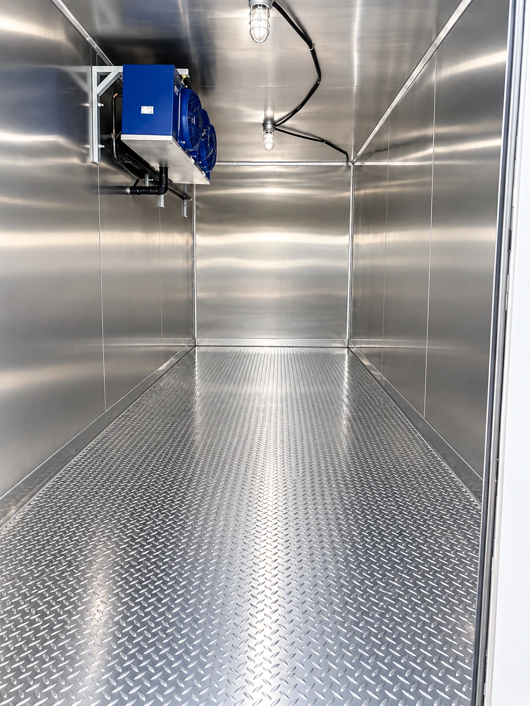 Empty stainless steel interior of a refrigerated trailer, ready for walk-in cooler or freezer overflow